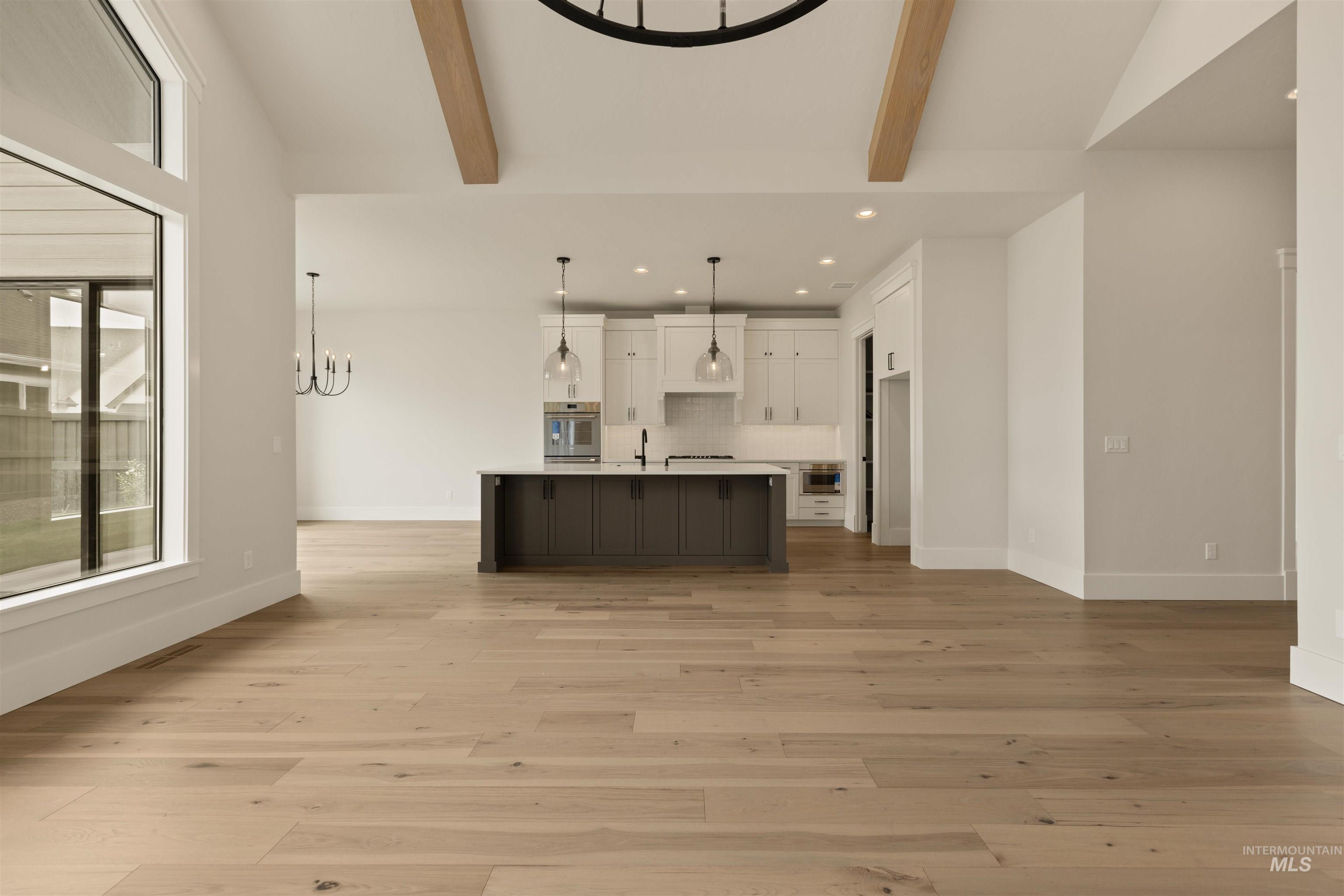 2595 East Tenzing Drive Meridian, ID 83642 - Photo 6 of 32 Unfurnished living room with a chandelier, recessed lighting, and light wood-style floors