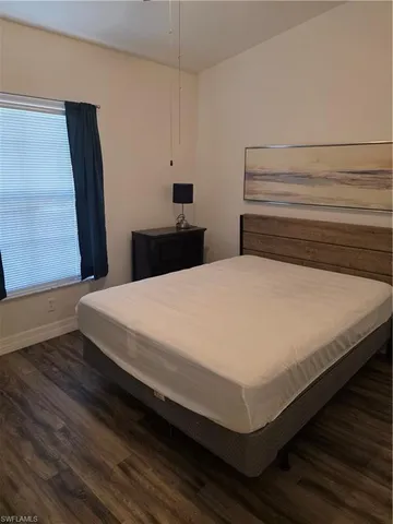a large bed sitting in a bedroom next to a window