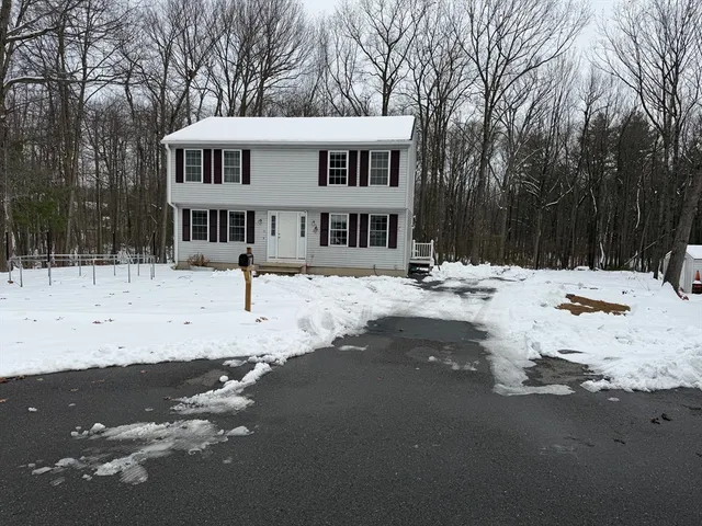 a view of a house with snow on the road