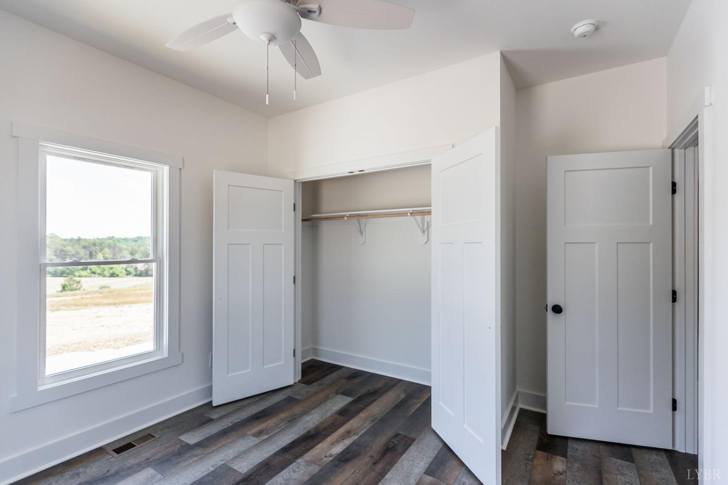 9740 Oakville Road Gladstone, VA 24553 - Photo 51 of 75 a view of an empty room with wooden floor and a window