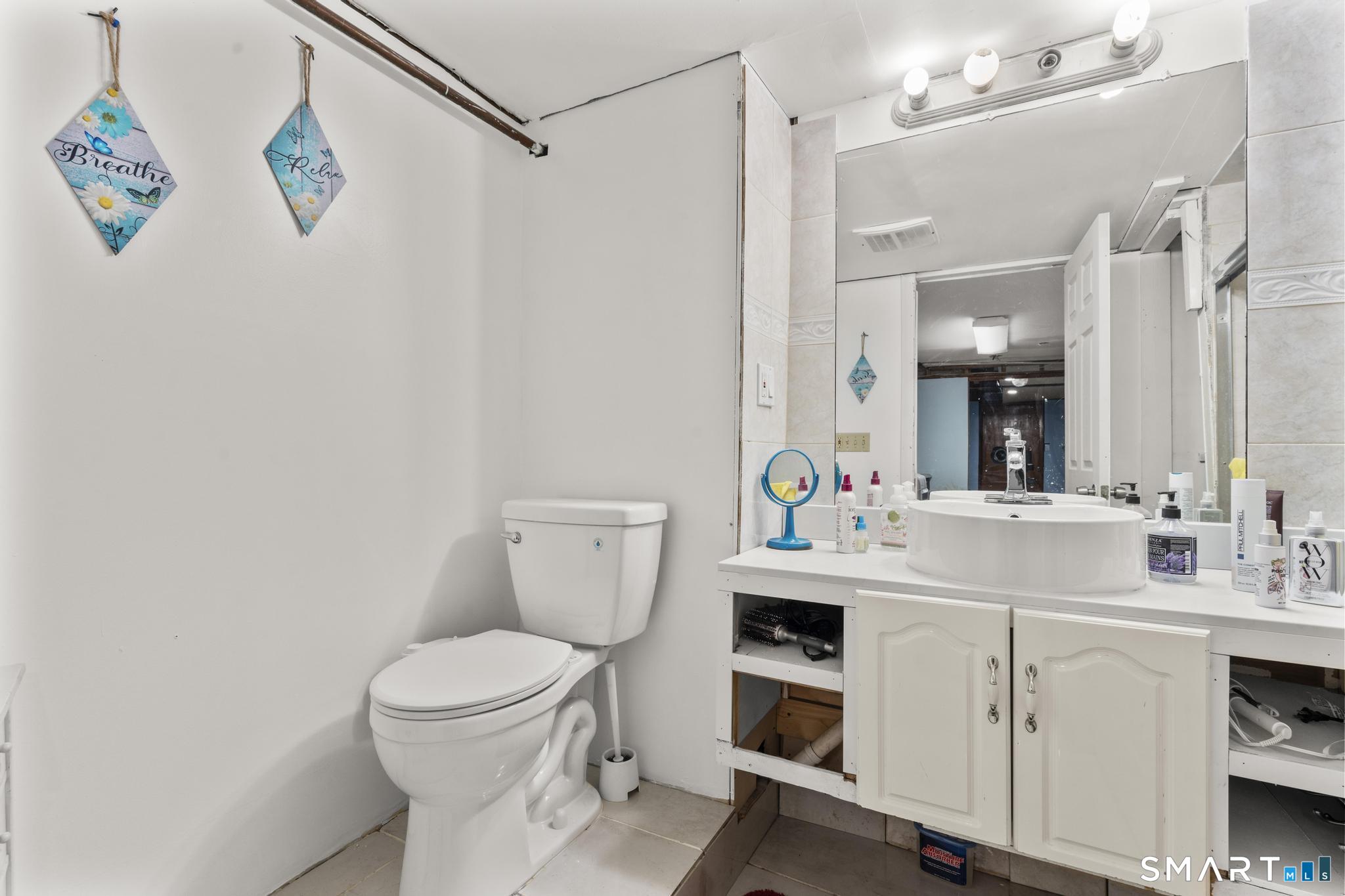 208 Bungay Road Seymour, CT 06483 - Photo 17 of 24 a bathroom with a sink a toilet and a mirror