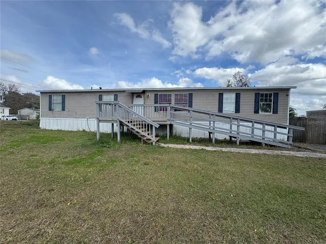 a view of a house with a backyard