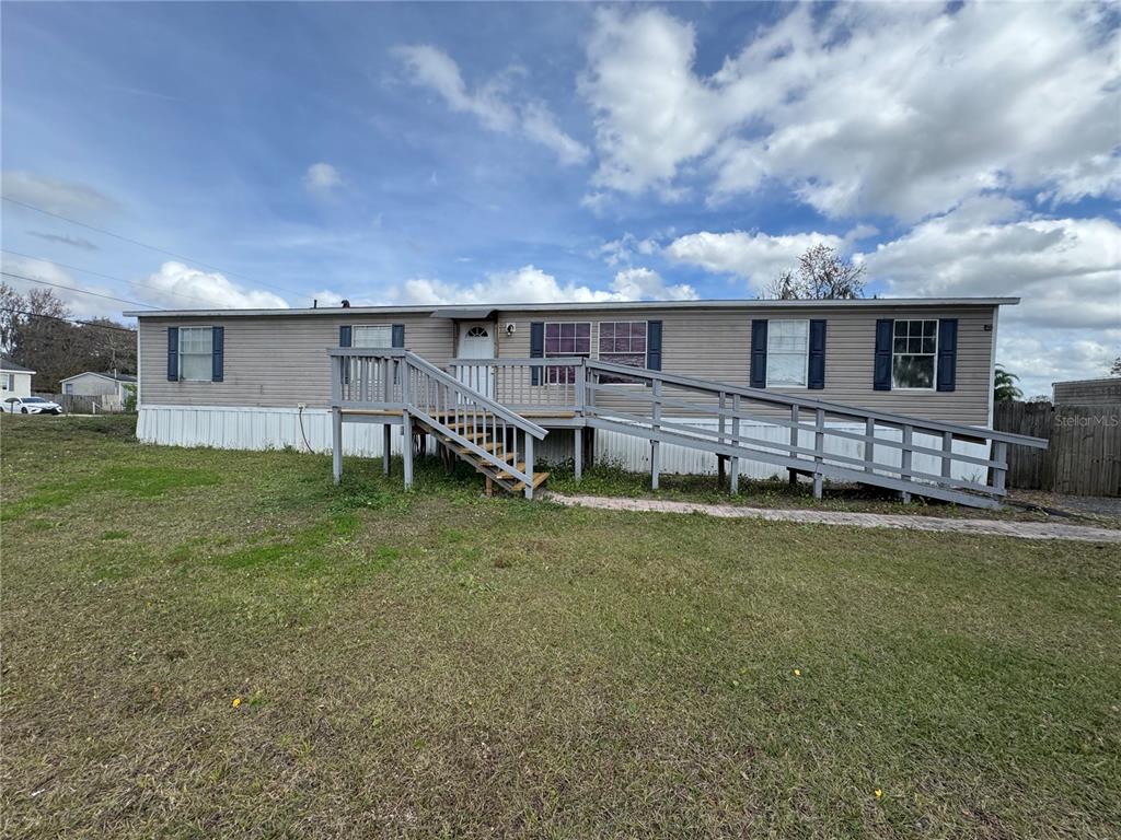 a view of a house with a backyard