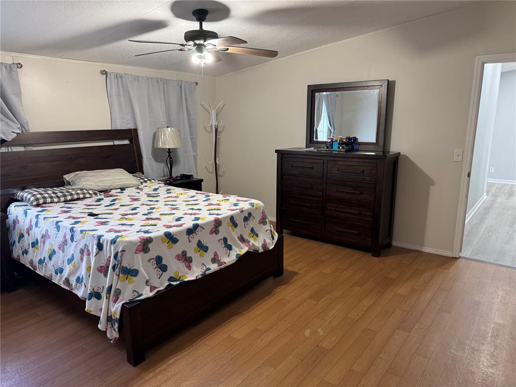 18806 Monroe Avenue Orlando, FL 32820 - Photo 12 of 44 a bedroom with a bed and a dresser