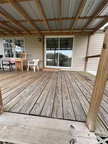 a view of outdoor space with wooden floor and seating
