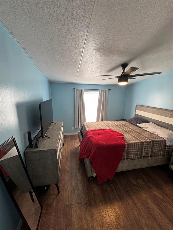 18806 Monroe Avenue Orlando, FL 32820 - Photo 21 of 44 a bedroom with a bed and wooden floor