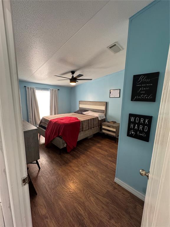 18806 Monroe Avenue Orlando, FL 32820 - Photo 22 of 44 a bedroom with a bed and a table in it
