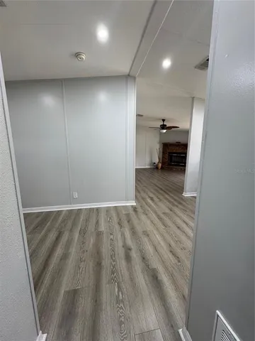 a view of hallway with wooden floor