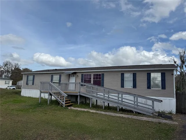 a view of a house with a backyard