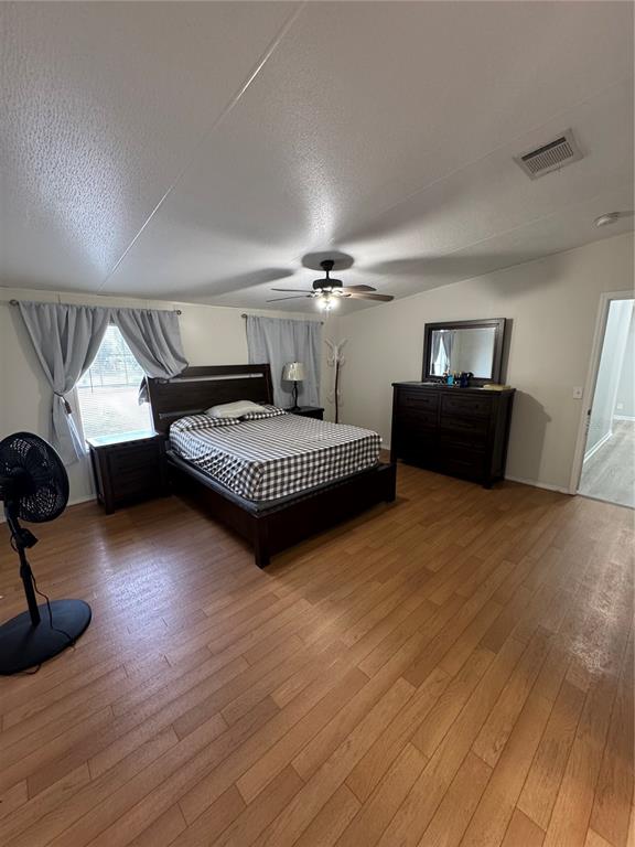 18806 Monroe Avenue Orlando, FL 32820 - Photo 35 of 44 a bedroom with furniture and a wooden floor