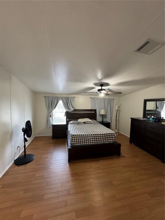 18806 Monroe Avenue Orlando, FL 32820 - Photo 36 of 44 a bedroom with a bed and a chandelier