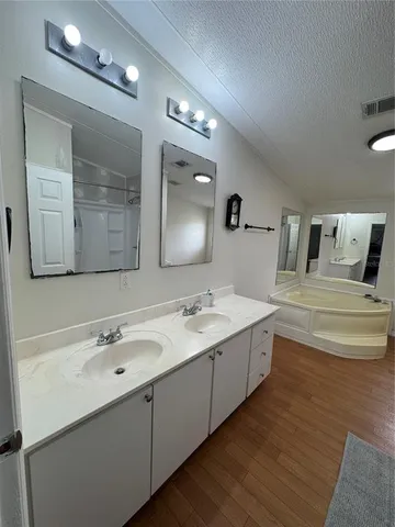 a bathroom with a sink mirror vanity and toilet