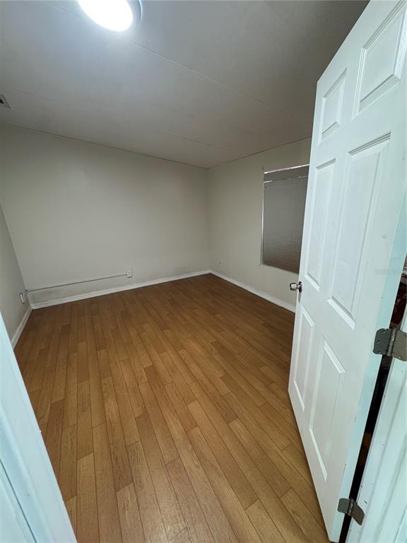 18806 Monroe Avenue Orlando, FL 32820 - Photo 43 of 44 a view of an empty room with wooden floor and stairs