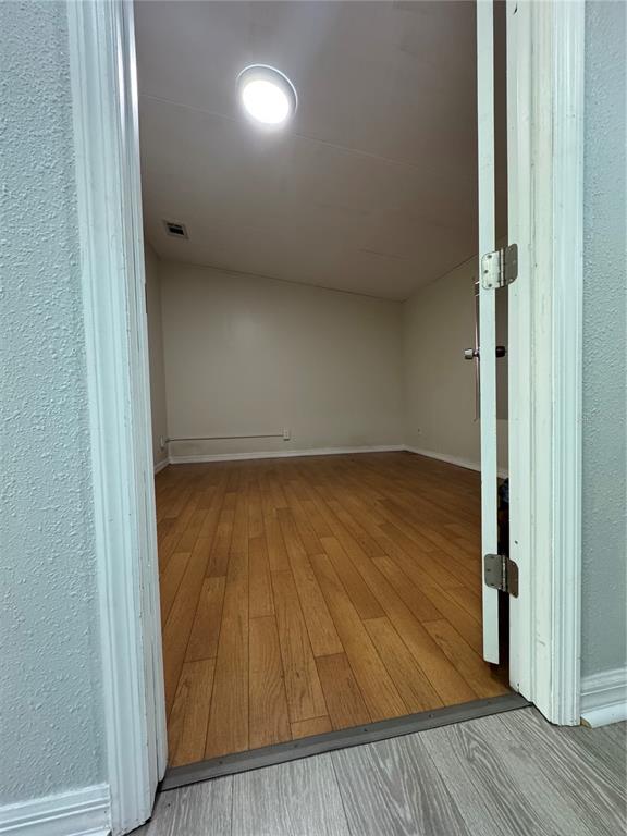 18806 Monroe Avenue Orlando, FL 32820 - Photo 44 of 44 an empty room with wooden floor and entrance