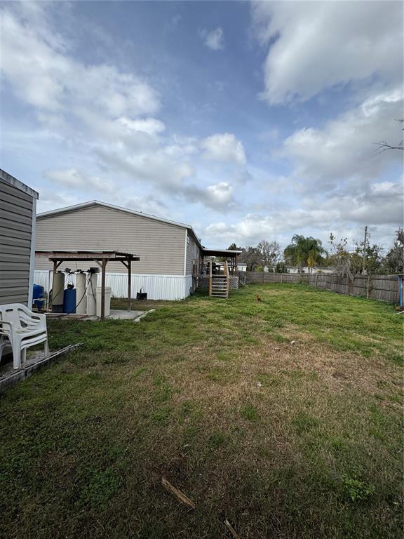 18806 Monroe Avenue Orlando, FL 32820 - Photo 7 of 44 a backyard of a house with table and chairs