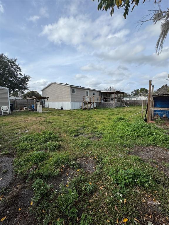 18806 Monroe Avenue Orlando, FL 32820 - Photo 8 of 44 a view of a house with a yard