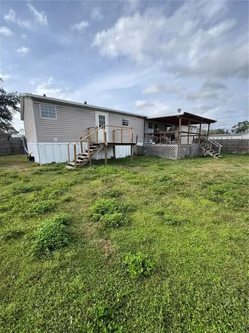 a view of a house with a yard and sitting area