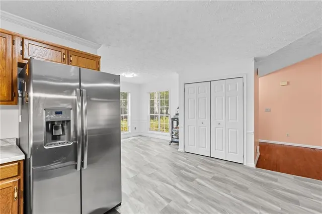a kitchen with stainless steel appliances granite countertop a refrigerator and a sink