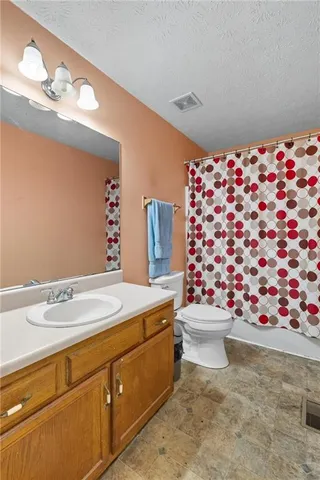 a bathroom with a sink mirror and toilet