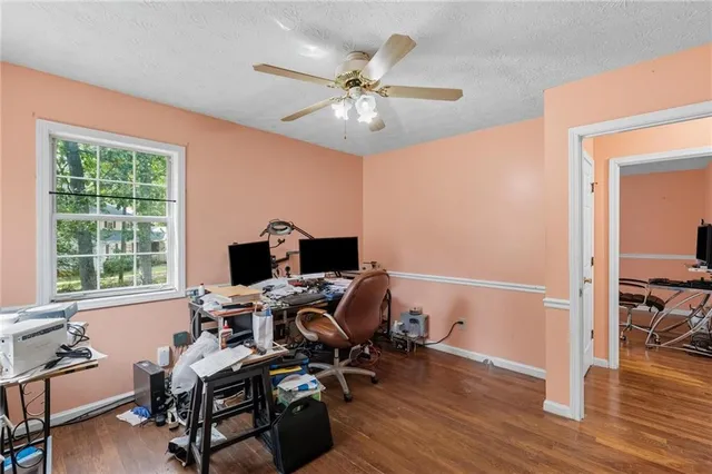 a view of a workspace with furniture and a window