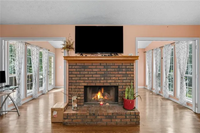 a living room with furniture fireplace and flat screen tv