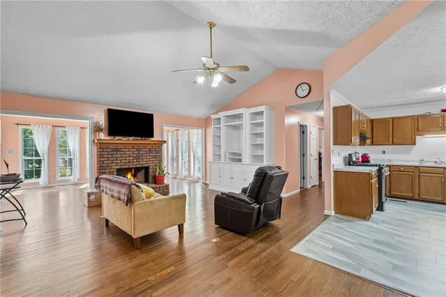 a living room with fireplace furniture and a flat screen tv