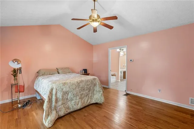 a bedroom with a bed and a ceiling fan
