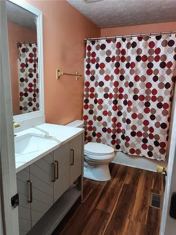 a bathroom with a toilet and a shower curtain