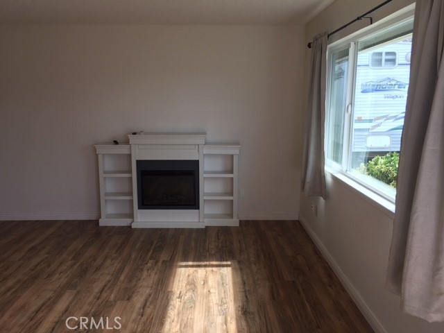 18745 Magnolia Court Hidden Valley Lake, CA 95467 - Photo 5 of 12 a view of empty room with wooden floor and fireplace
