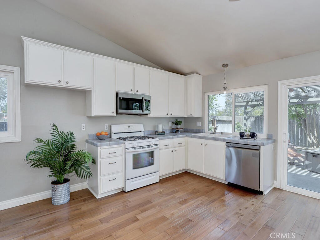 22661 Claude Circle Lake Forest, CA 92630 - Photo 11 of 50 a kitchen with a white stove top oven and white cabinets