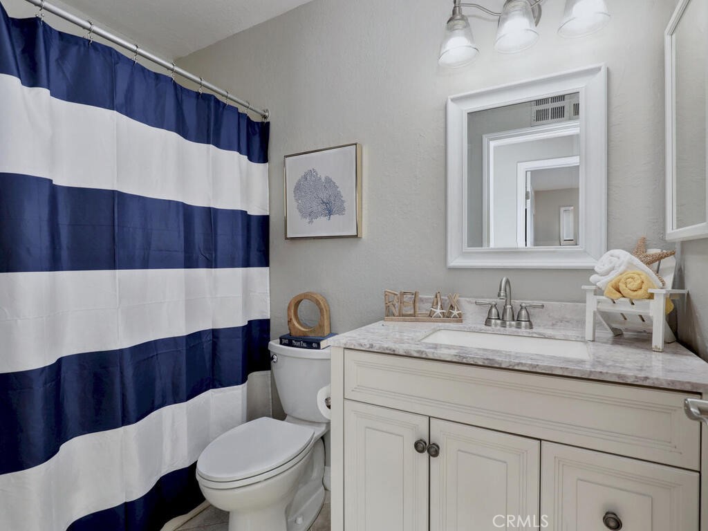 22661 Claude Circle Lake Forest, CA 92630 - Photo 12 of 50 a bathroom with a sink a toilet and a mirror