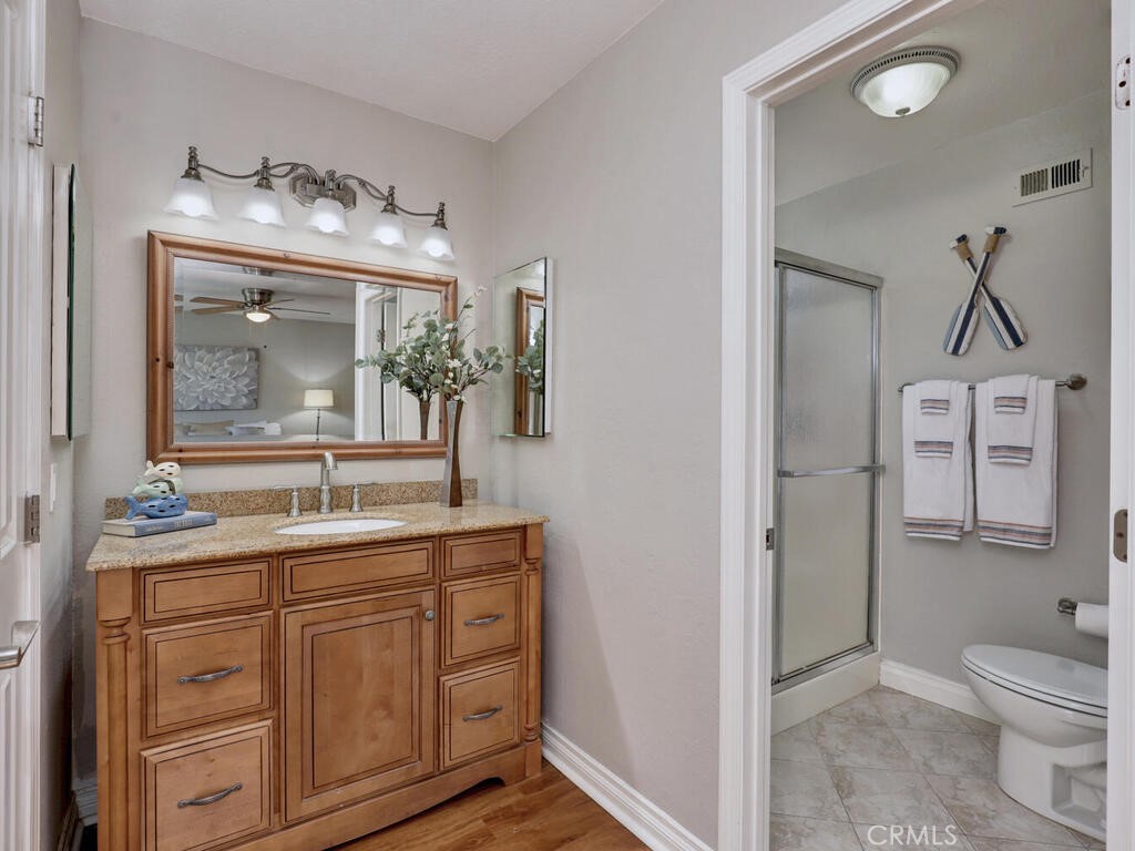 22661 Claude Circle Lake Forest, CA 92630 - Photo 15 of 50 a bathroom with a toilet sink and mirror