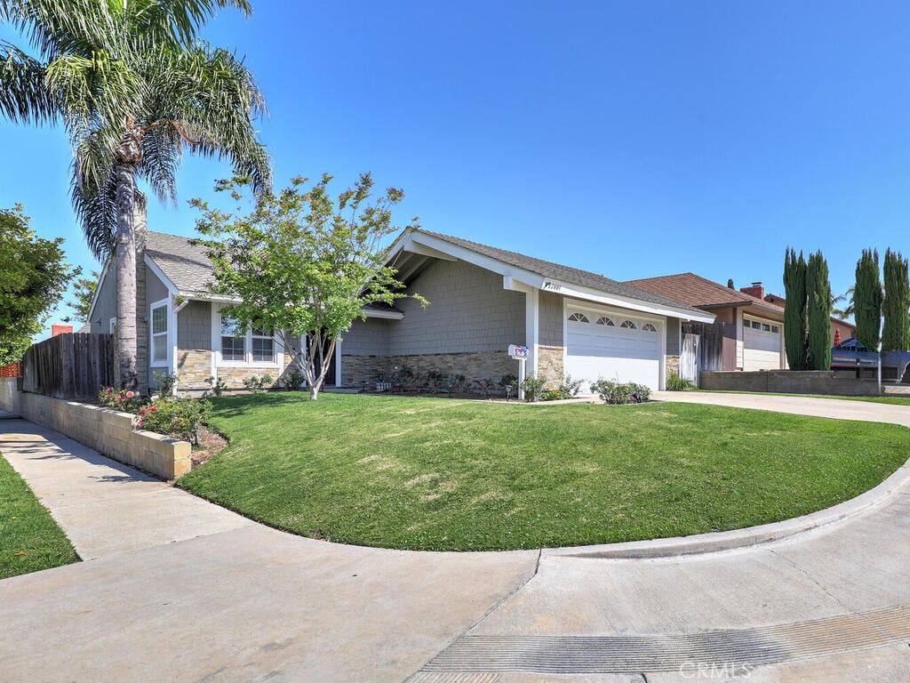 22661 Claude Circle Lake Forest, CA 92630 - Photo 2 of 50 a view of a house with a small yard and a garden