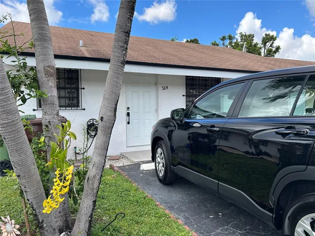 a view of a patio with table and chairs