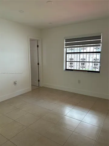 an empty room with a empty space and windows