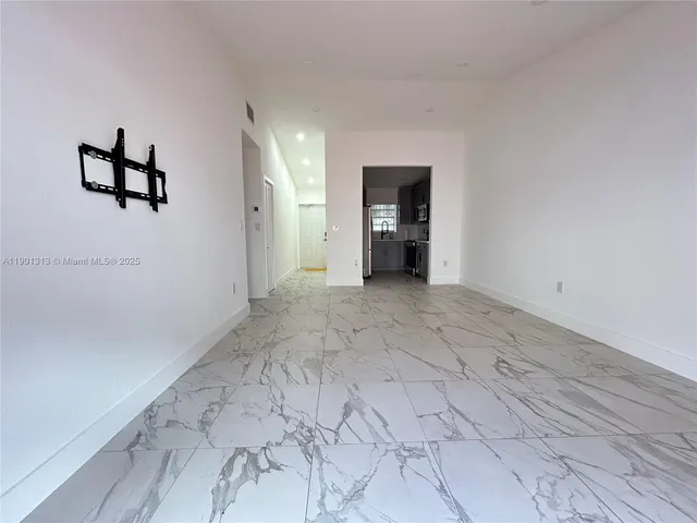 a view of a livingroom with a dishwasher and cabinets