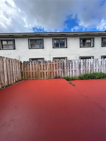 a view of a house with backyard and kitchen
