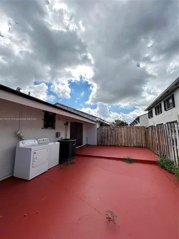 a room with a refrigerator and washer