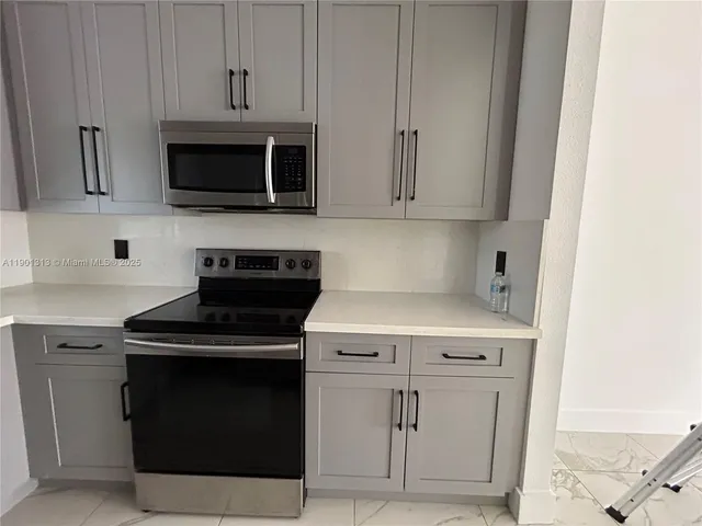 a close view of fireplace stove and microwave