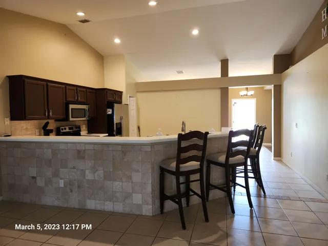 a view of kitchen and kitchen with stainless steel appliances