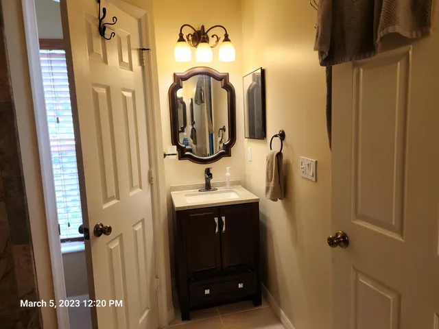 a bathroom with a sink vanity and a mirror