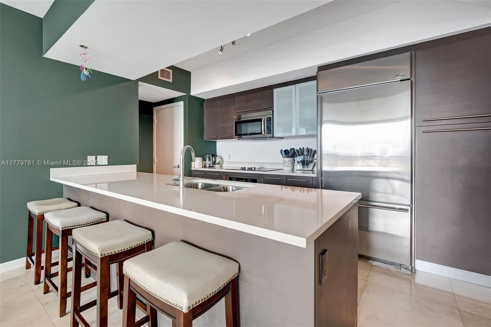 Brickell Miami, FL 33131 - Photo 3 of 52 a kitchen with a sink a stove and chairs