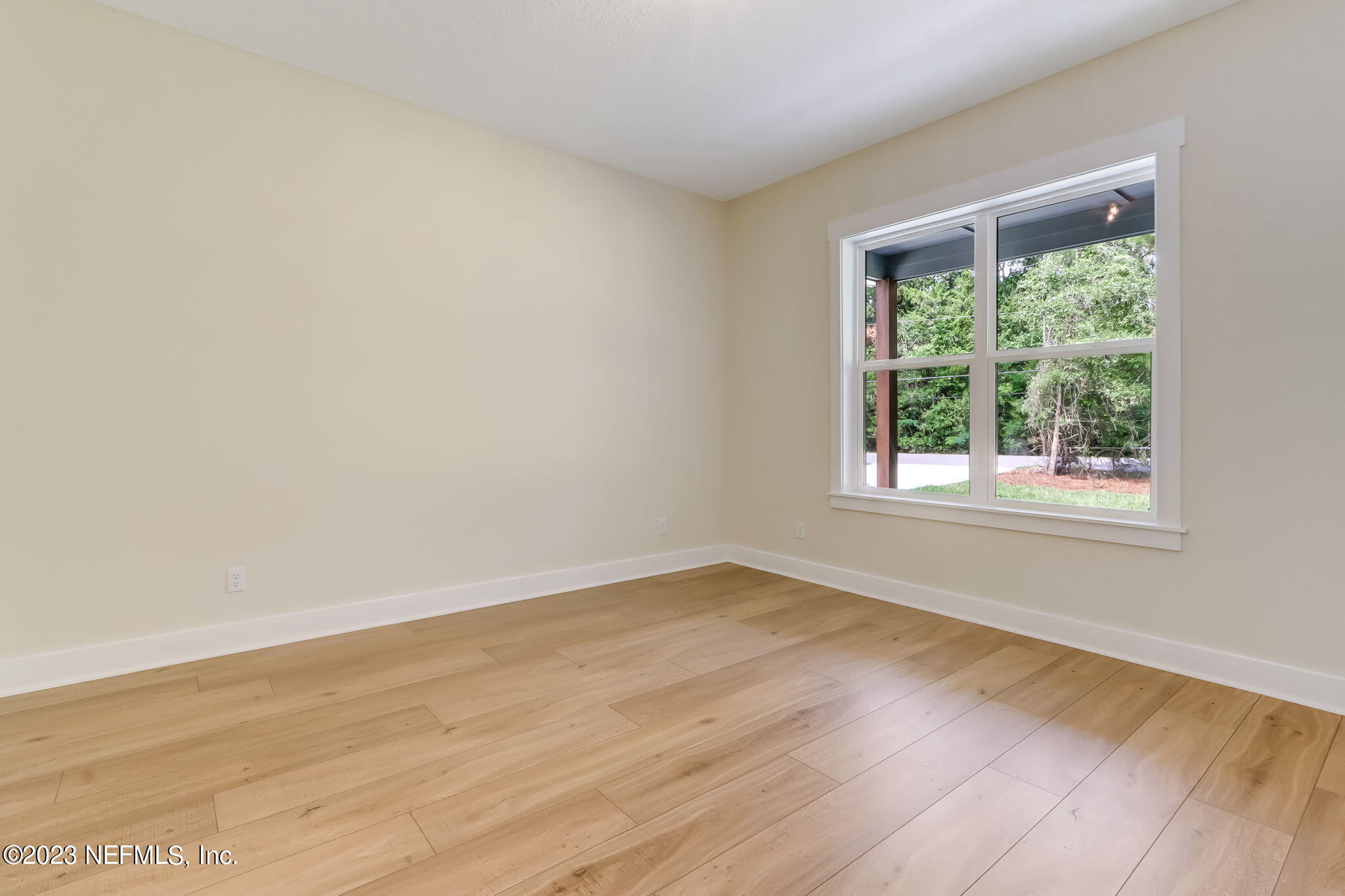 86277 Peeples Road Yulee, FL 32097 - Photo 22 of 36 a view of an empty room with wooden floor and a window