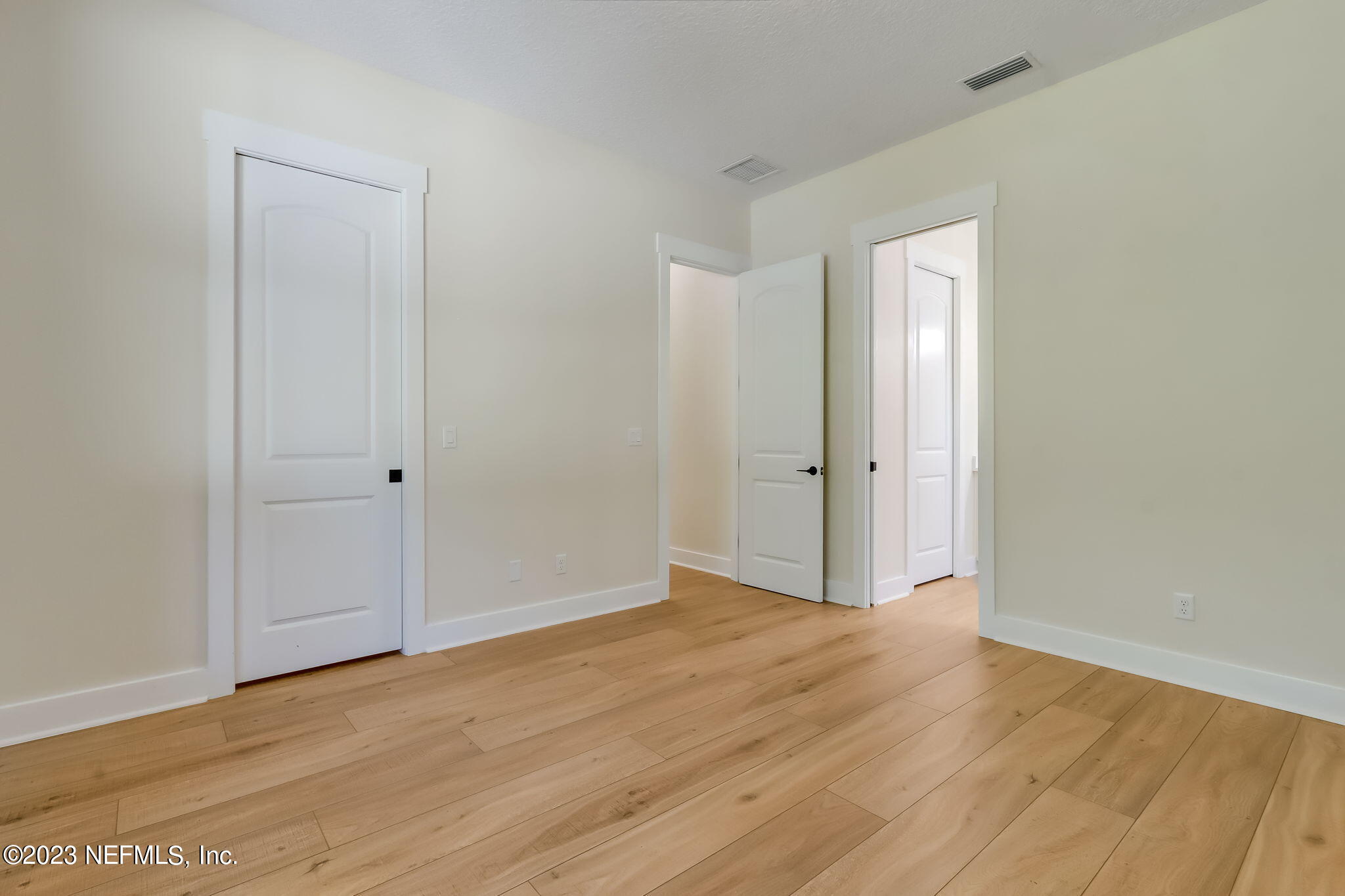 86277 Peeples Road Yulee, FL 32097 - Photo 23 of 36 a view of an empty room with wooden floor