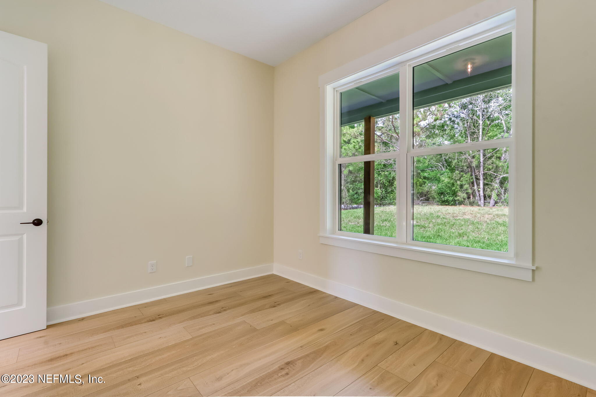 86277 Peeples Road Yulee, FL 32097 - Photo 27 of 36 a view of an empty room with wooden floor and a window
