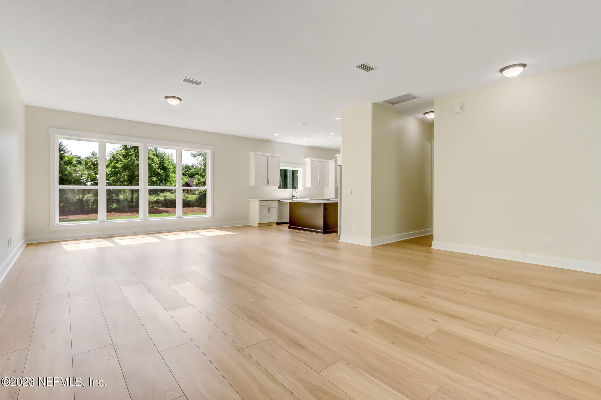 86277 Peeples Road Yulee, FL 32097 - Photo 8 of 36 a view of empty room with wooden floor and windows