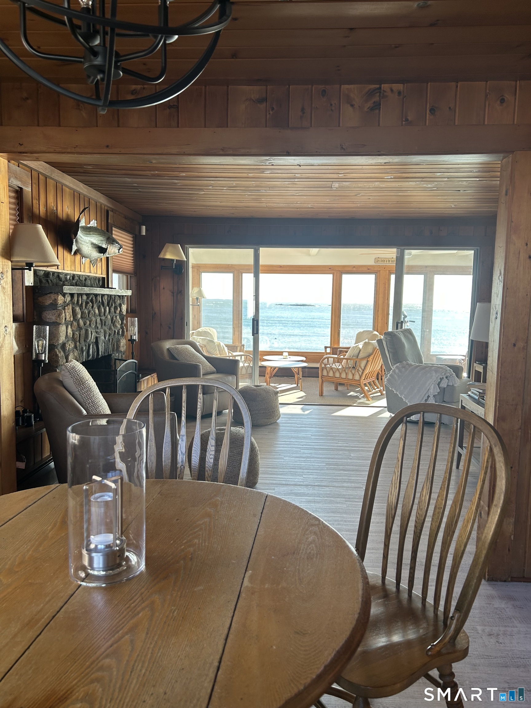 293 Giants Neck Road East Lyme, CT 06357 - Photo 3 of 21 a view of a dining room with furniture large windows and wooden floor