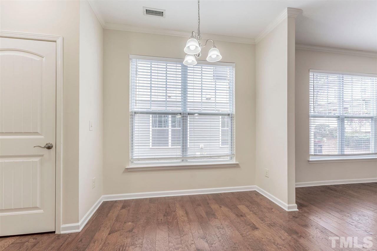 2431 Swans Rest Way Raleigh, NC 27606 - Photo 11 of 25 an empty room with wooden floor and windows