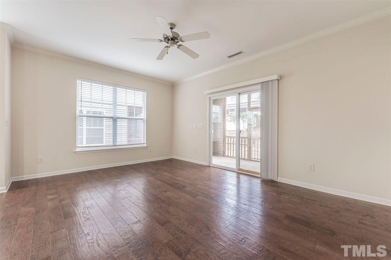 2431 Swans Rest Way Raleigh, NC 27606 - Photo 12 of 25 a view of an empty room with a window and wooden floor