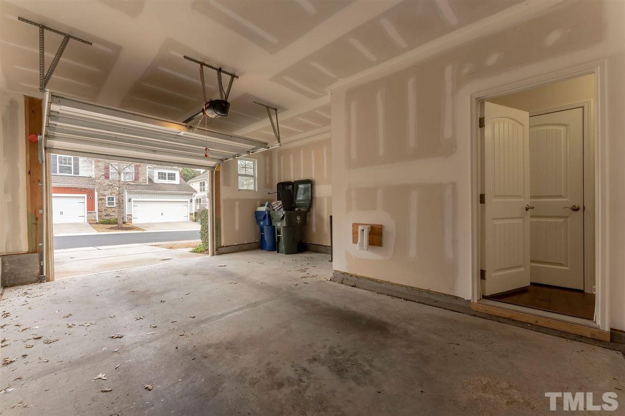 2431 Swans Rest Way Raleigh, NC 27606 - Photo 24 of 25 a view of a hallway with wooden shelves
